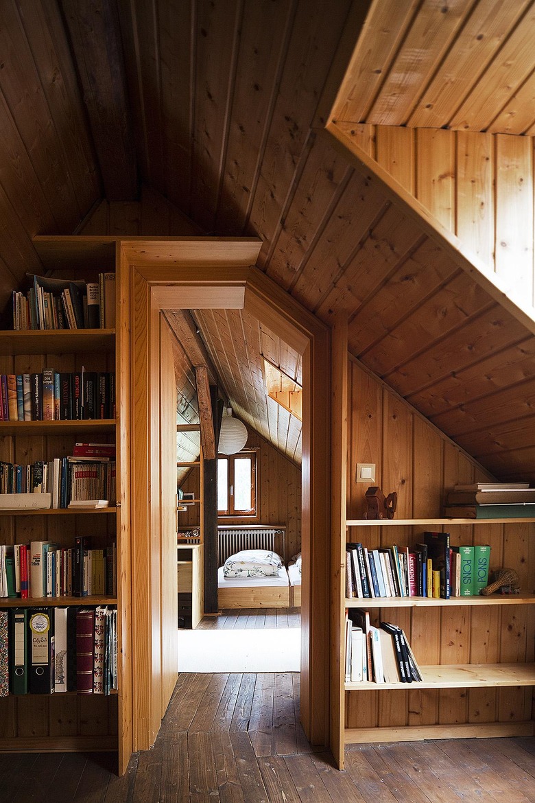 small attic library in rustic home with built-in bookcases