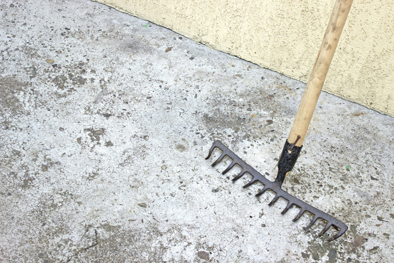 Rake tool over concrete background