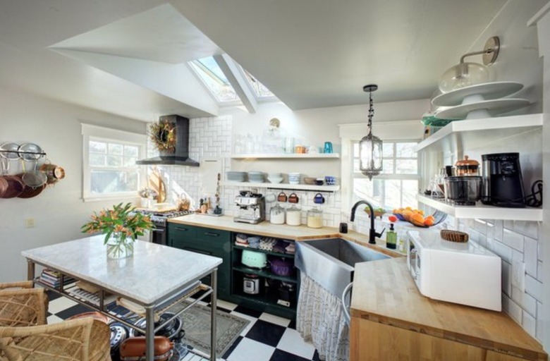 Small kitchen with skylight, checker tile floors.