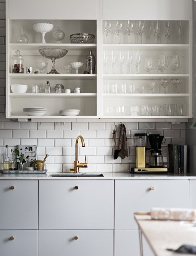 small kitchen design with gray cabinets and open shelving with subway tile backsplash