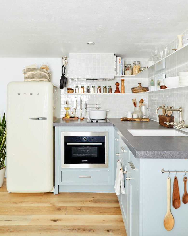 small kitchen layout idea with blue cabinets and open shelving