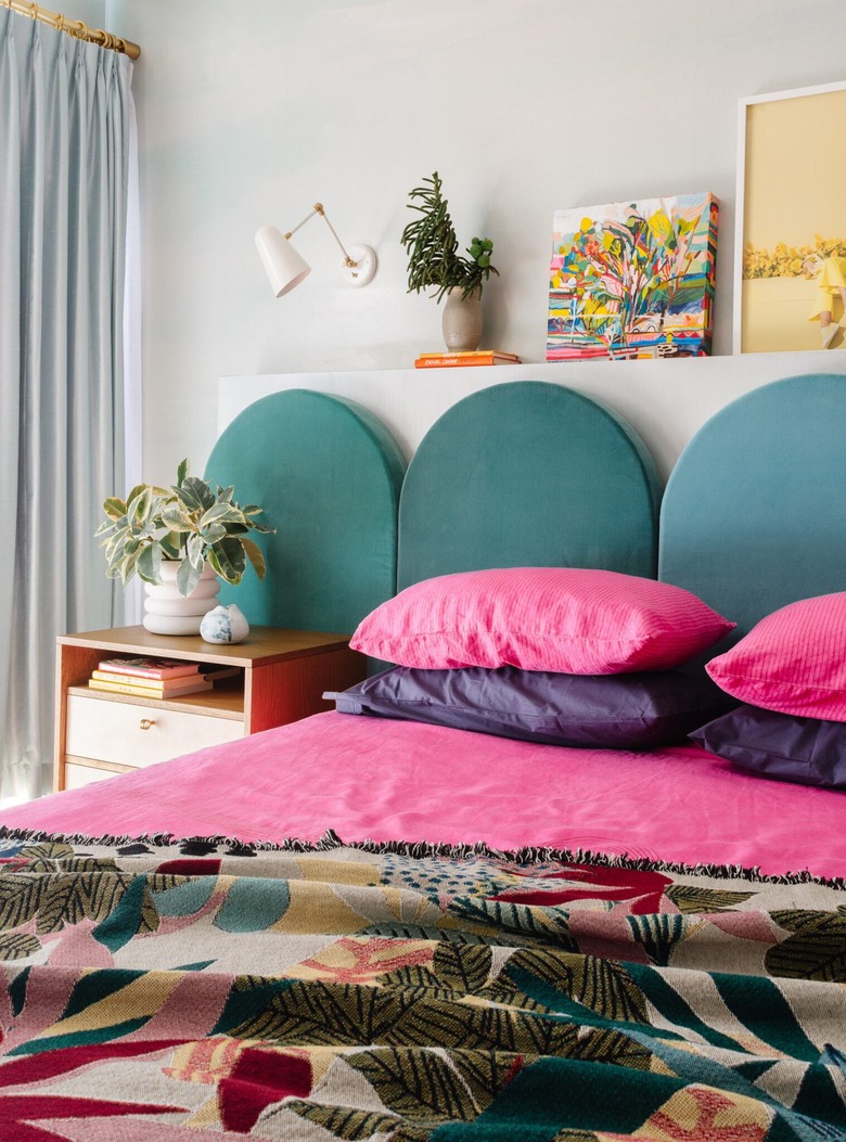 colorful small bedroom with arched headboard