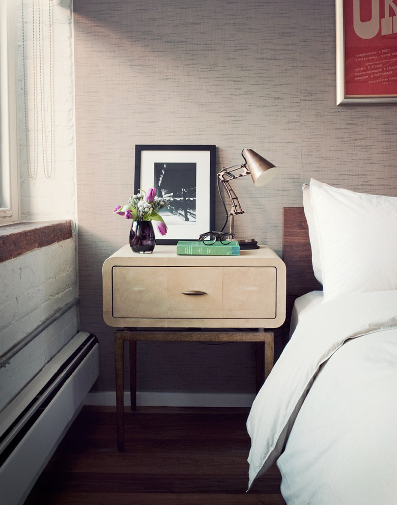 Small master bedroom idea with wallpaper and small nightstand