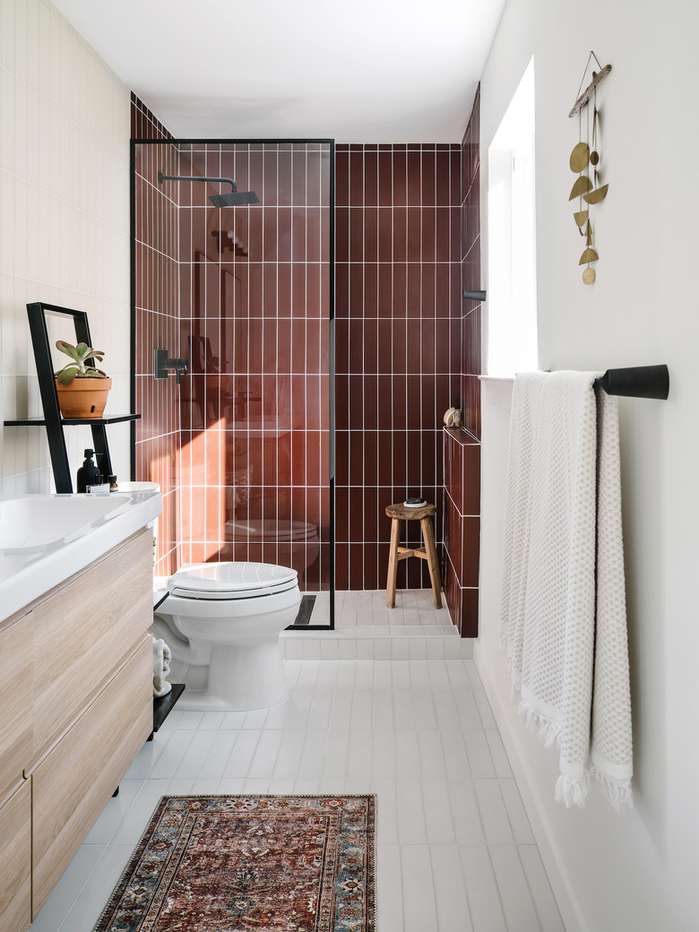 small midcentury modern bathroom with rust shower and white subway tile