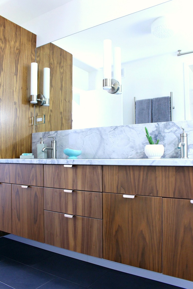 small midcentury modern bathroom with walnut cabinets and marble countertop