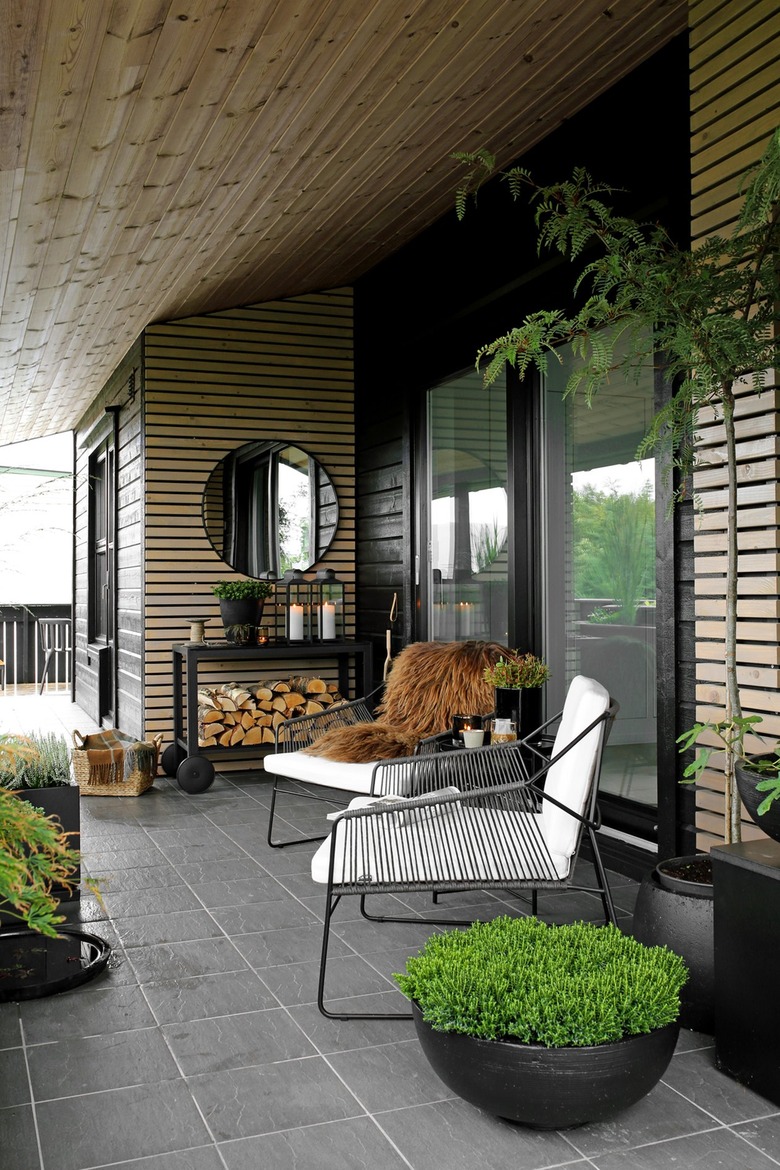 cozy outdoor patio with wood walls and modern chairs