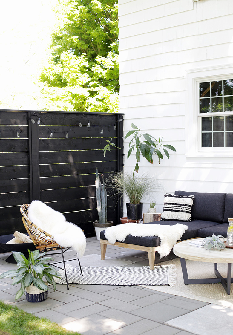 Black and white small patio ideas with throw pillows, rugs, and faux fur