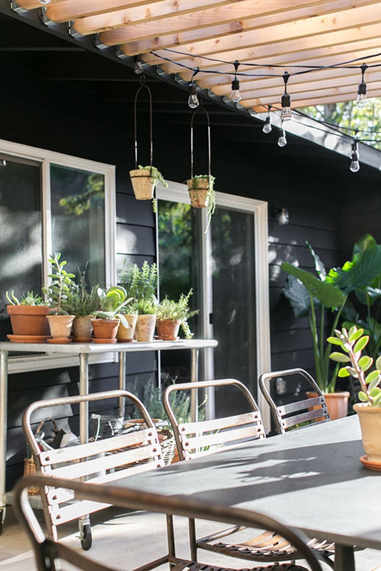 black exterior with outdoor patio and potting area