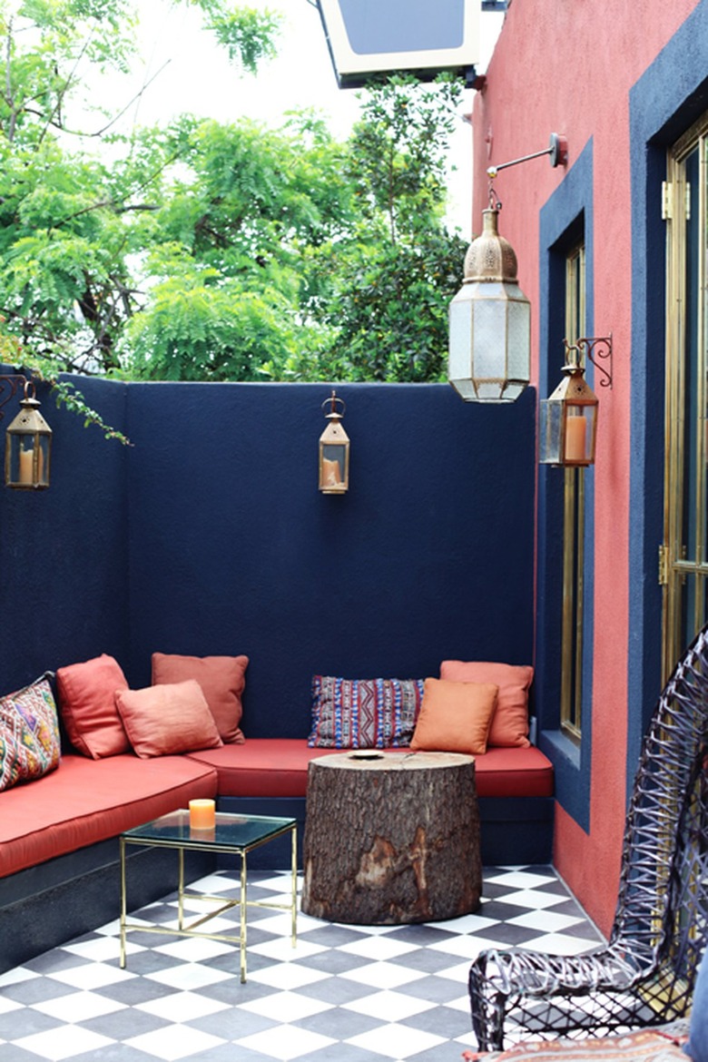 colorful outdoor patio with wall seating and throw pillows