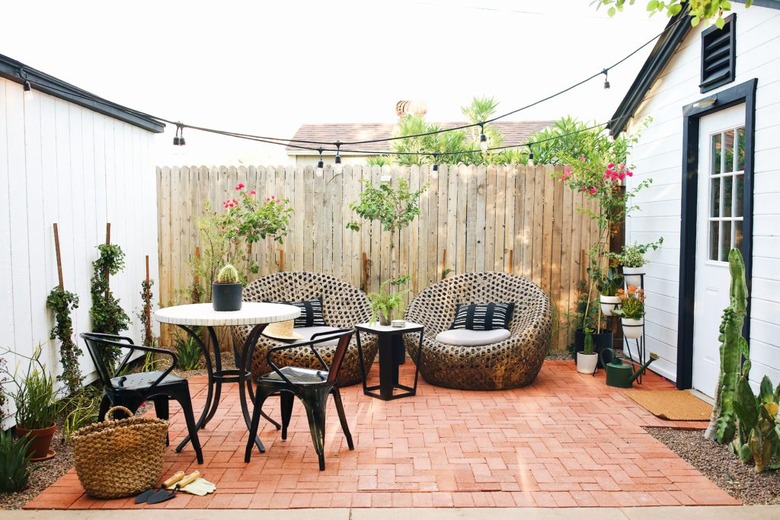 Contemporary small patio ideas with black and white bistro set and lounge chairs