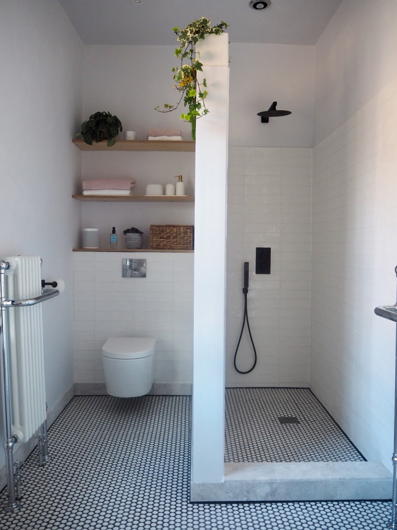 white boho bathroom with small shower and wall divider