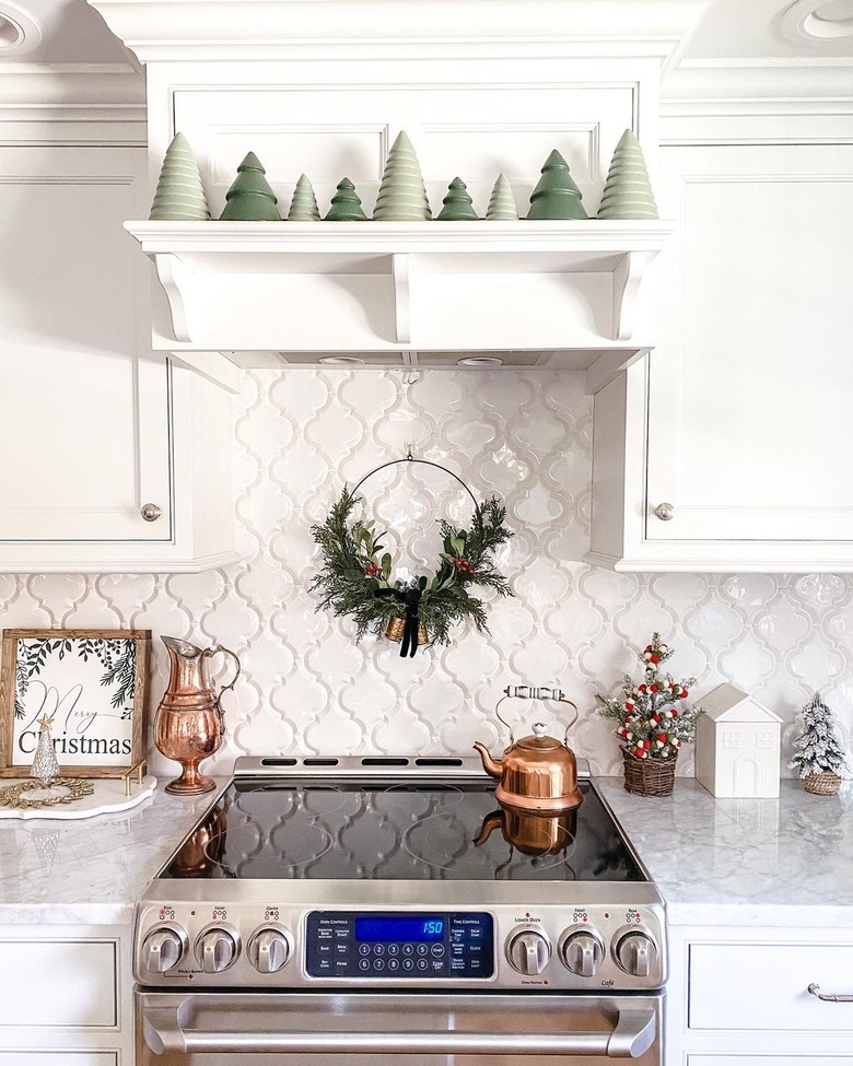 kitchen with trees on shelf and wreath on backsplash