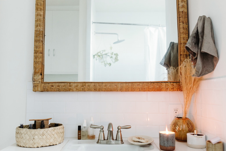 bathroom sink with wood frame mirror