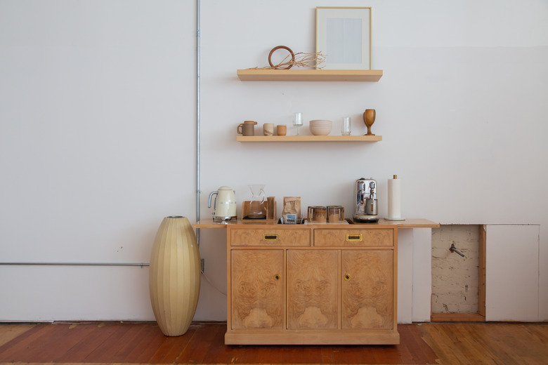 dresser with shelves above it