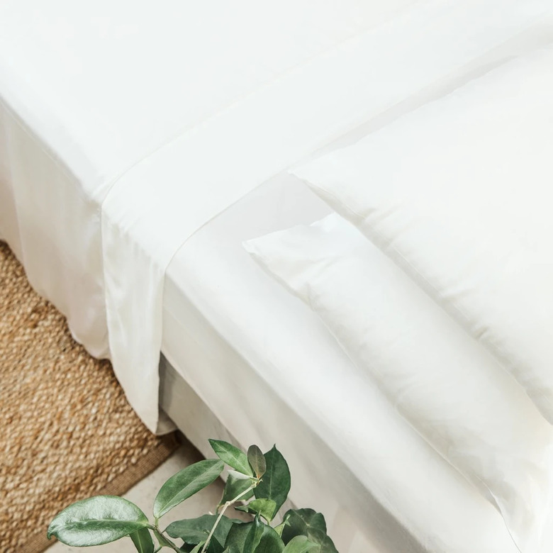 overhead photo of a bed with white sheets