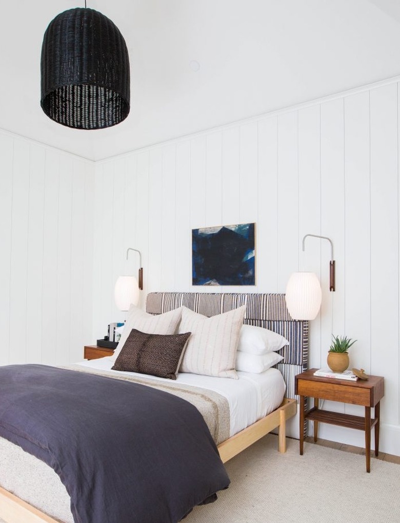 neutral bedroom idea with black pendant and upholstered headboard