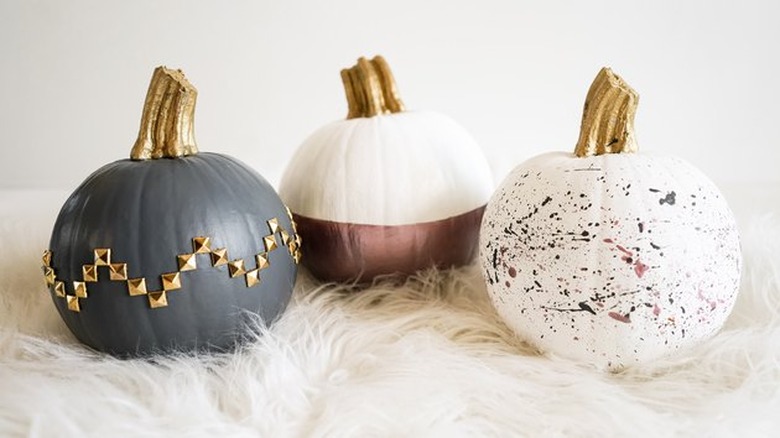 showing three no-carve pumpkins with various paint effects