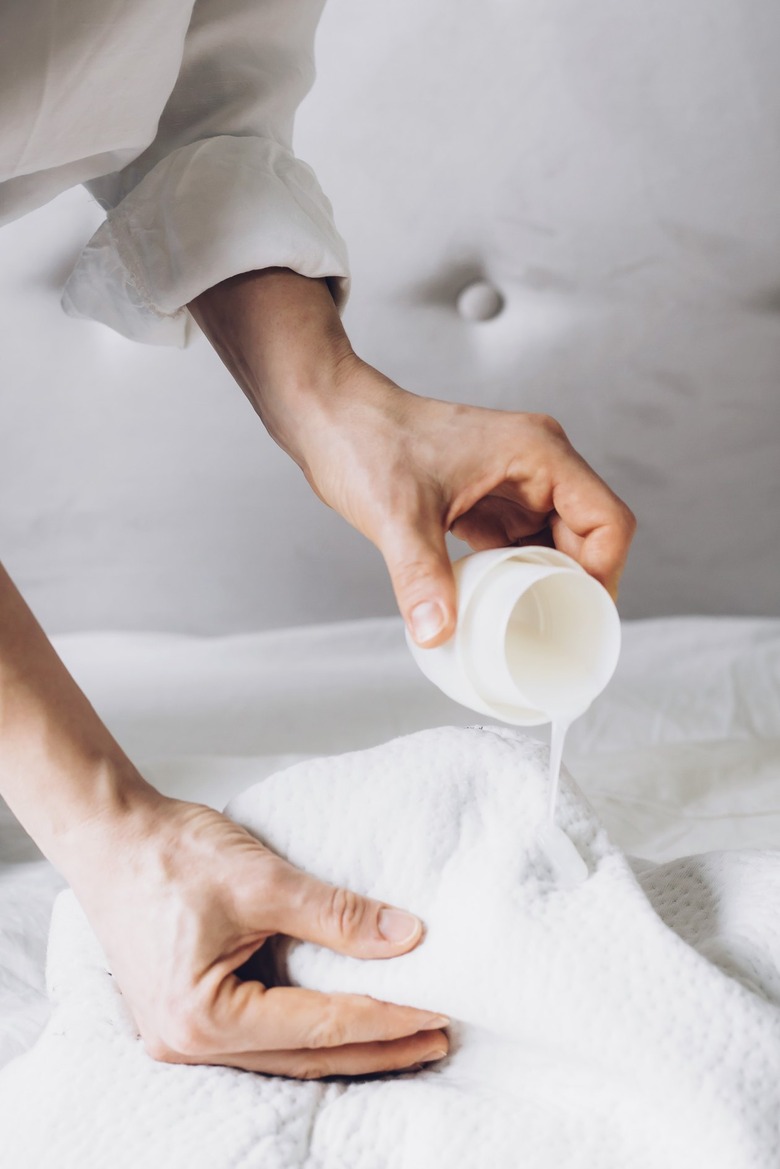 White bed sheet with clear laundry detergent