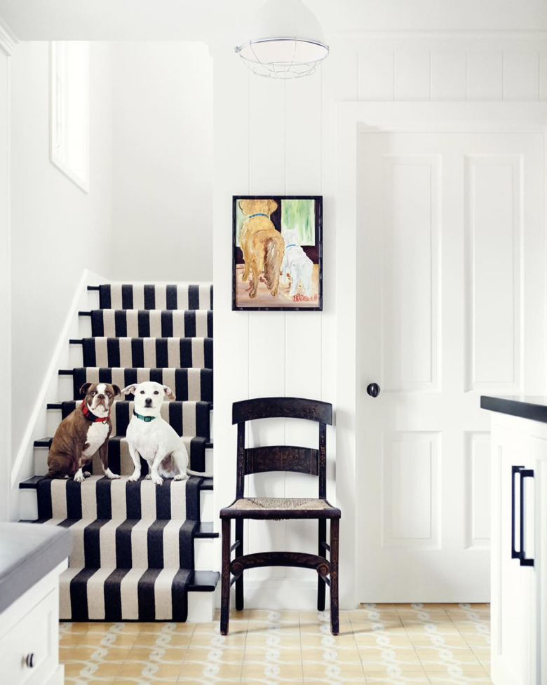 Cabana stripe stair runners in white entryway with dog painting