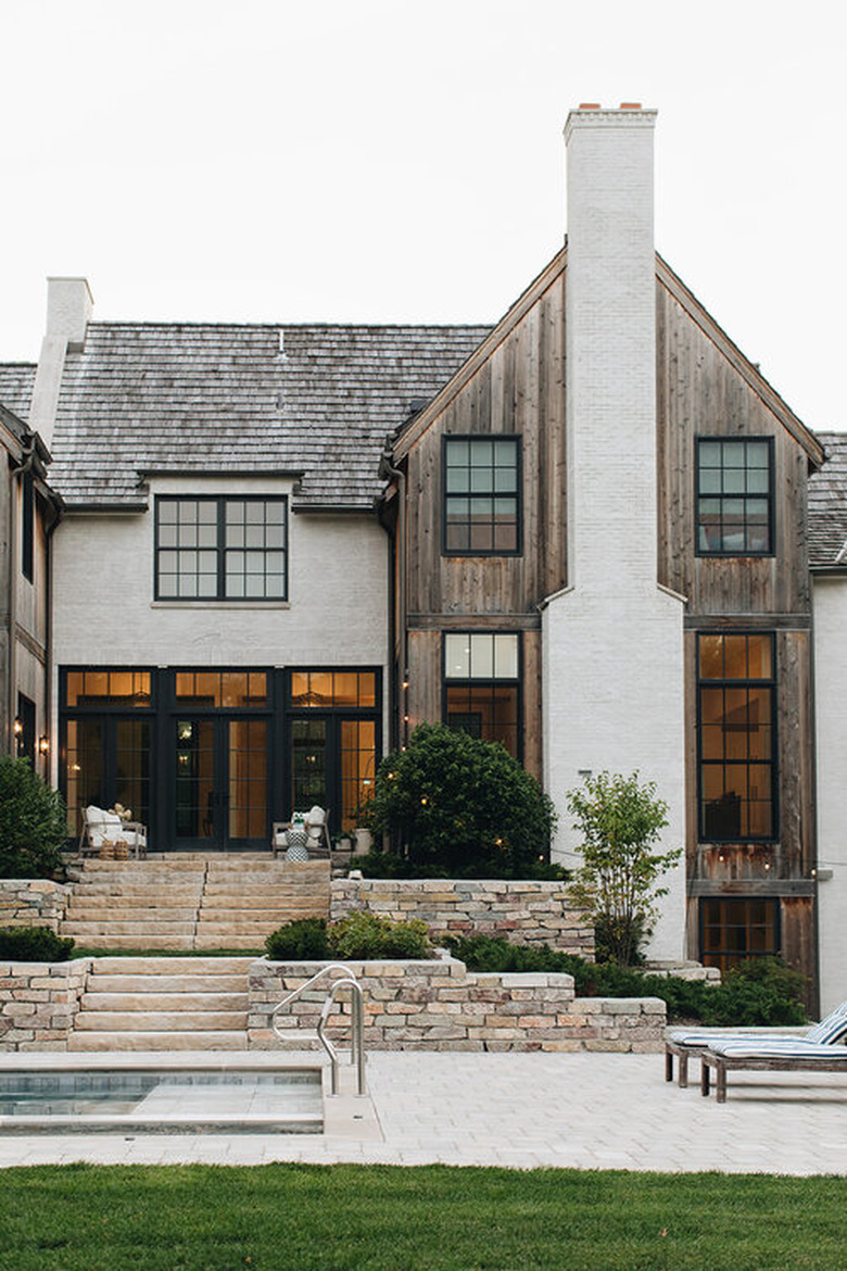 Stone Exterior Homes with Stone, wood and brick home by Kate Marker Interiors