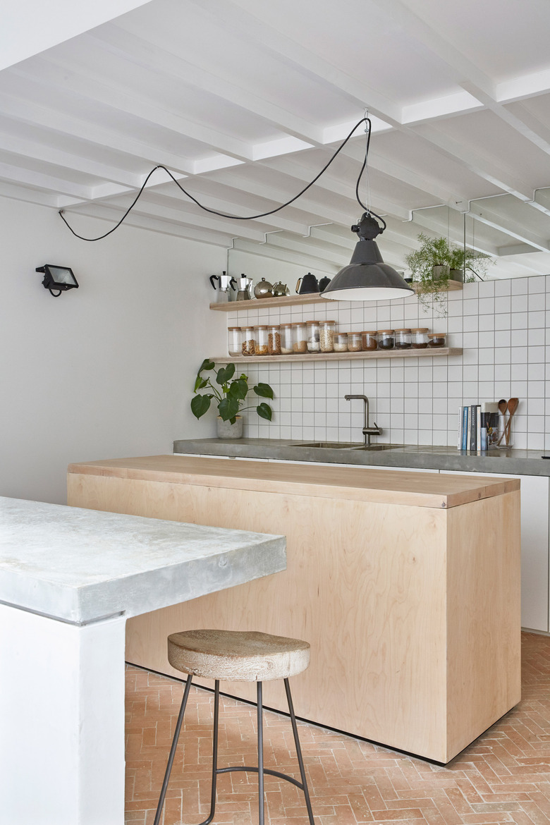 full height grid kitchen backsplash with wood island and concrete countertops