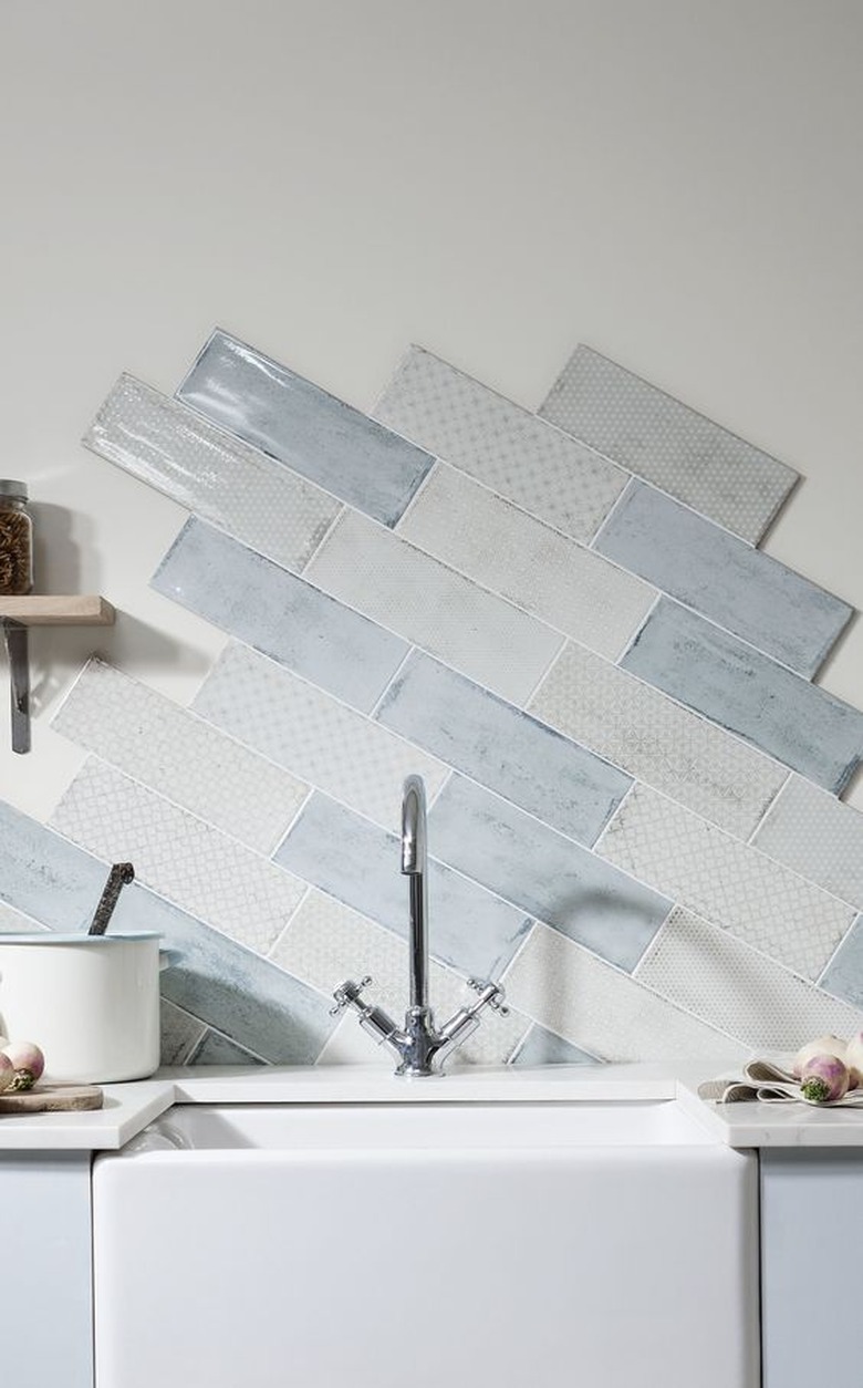 unfinished blue and white kitchen backsplash with farmhouse sink