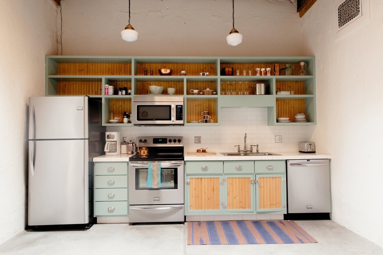 Small kitchen in adobe row house in Arizona with stove vent