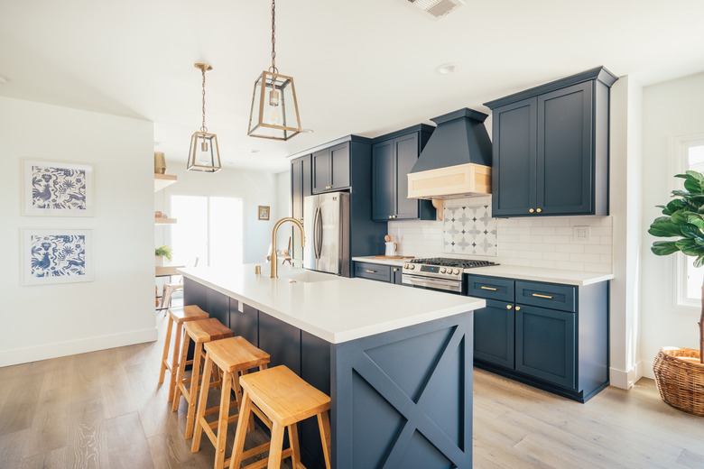 Blue kitchen cabinets in Los Angeles remodel with stove vent