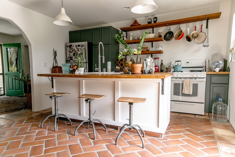 Clay tile floor in kitchen with bar stools