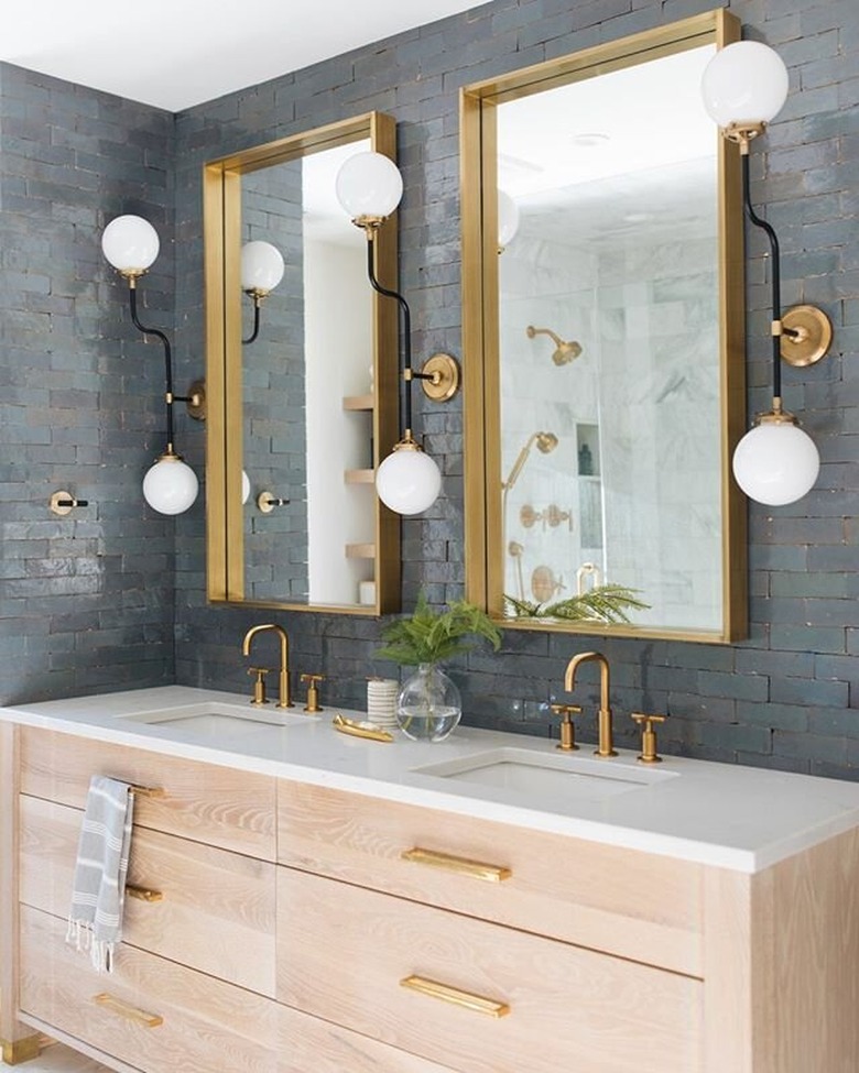 blue subway tile with trio of architectural sconces