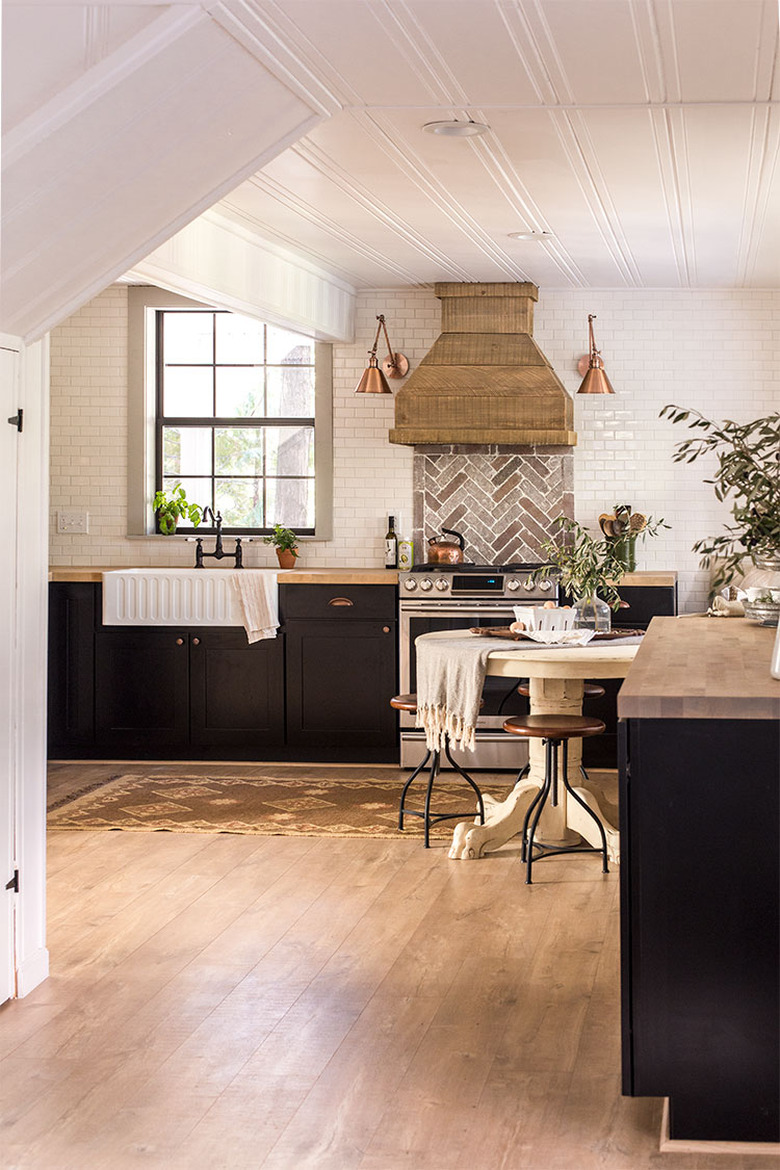 white subway tile backsplash with brick backsplash behind range