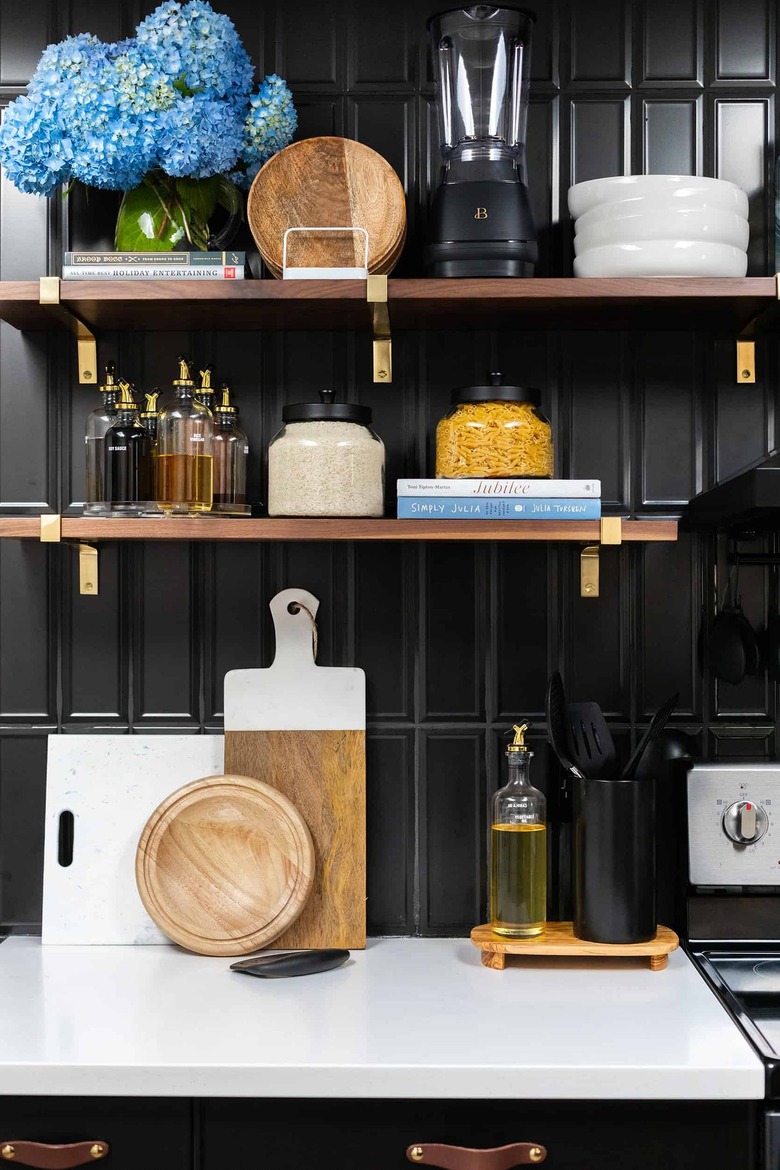 black subway tile backsplash with floating shelves