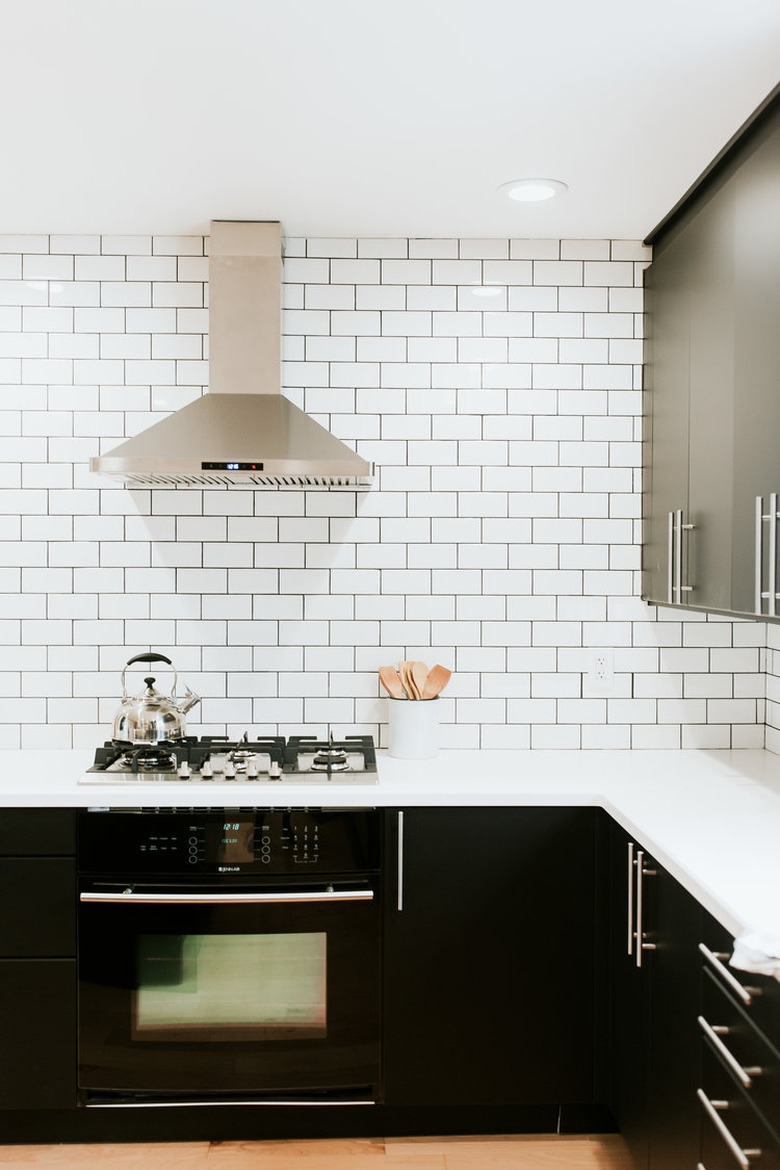 classic white subway tile kitchen backsplash with dark cabinetry