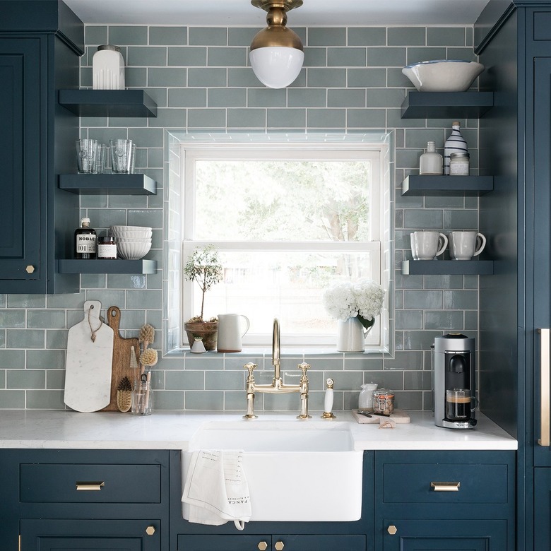 light blue backsplash with dark blue cabinets