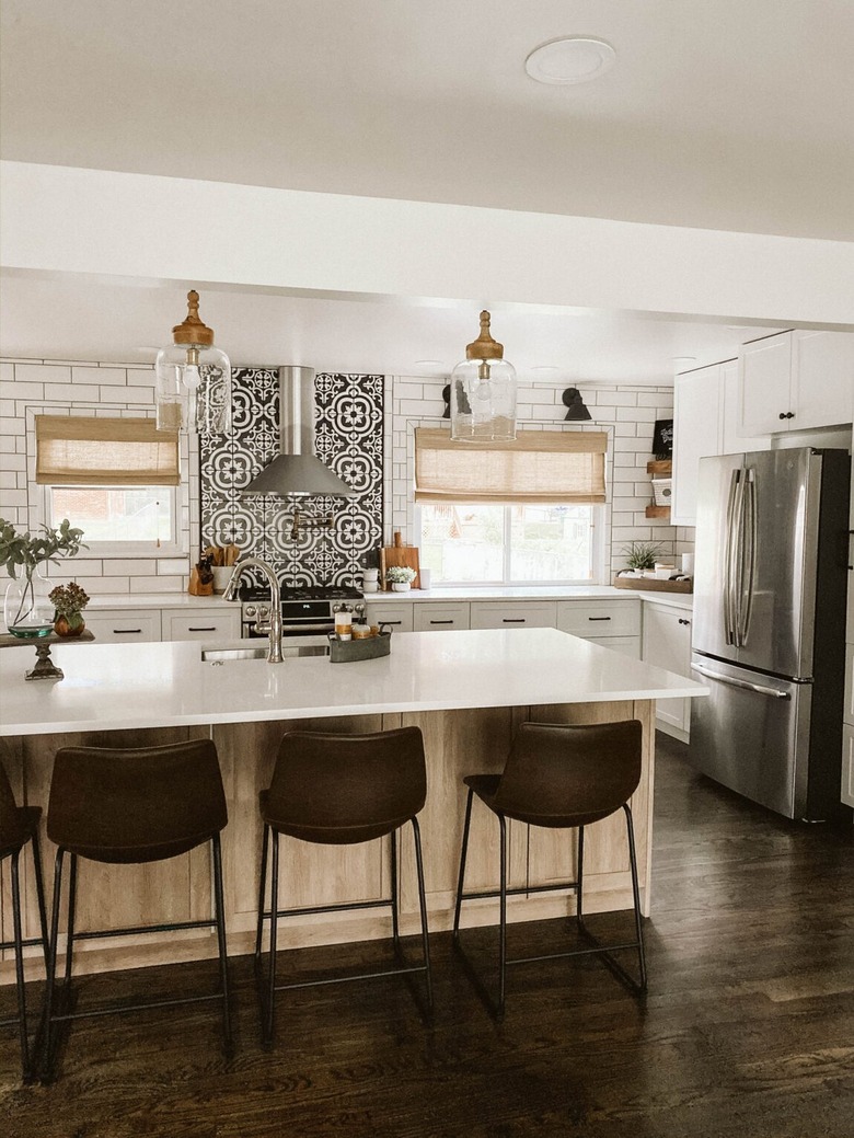 white subway tile backsplash with black and white tile behind range