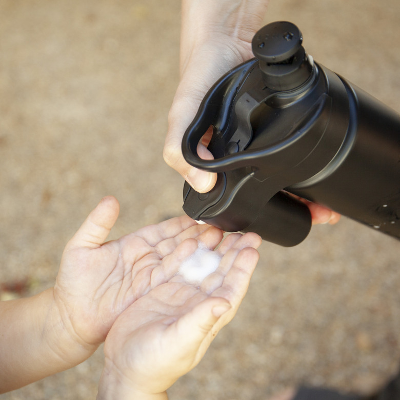 washing hands with suds2go bottle