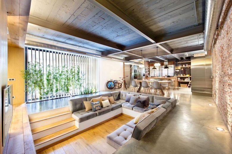 sunken living room with built-in seating and tufted cushions