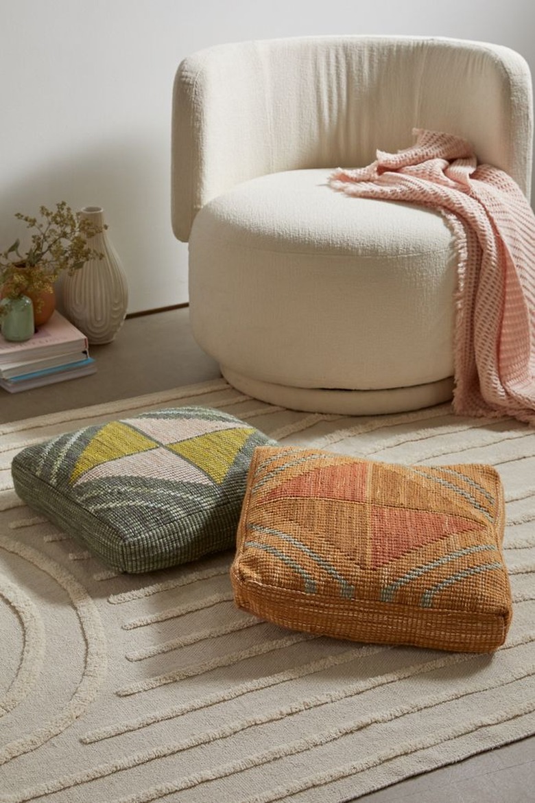 ways to decorate for fall floor pillows and cream chair