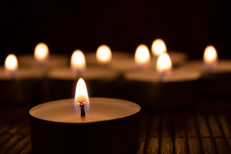 Close-Up Of Lit Candles In Darkroom