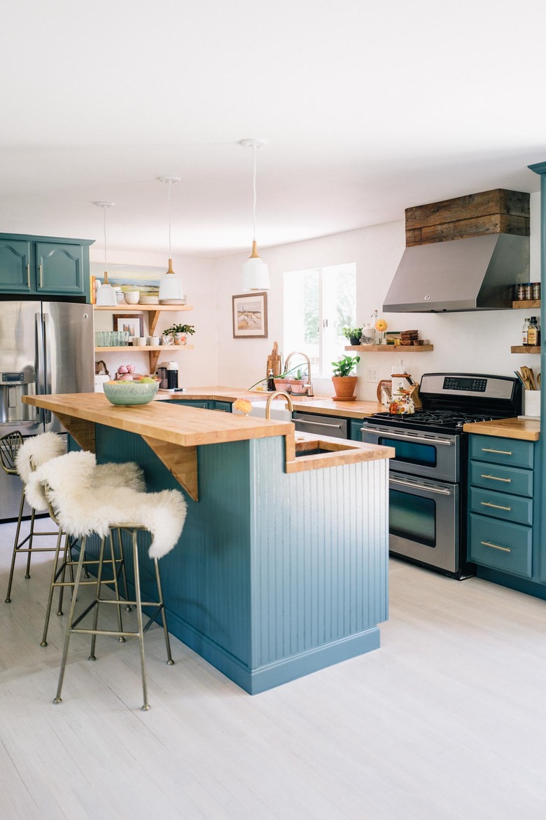 Teal kitchen idea with light wood countertops and bohemian decor