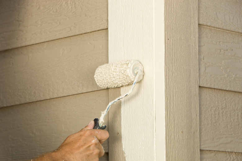 House Painter Rolling Siding Trim Board