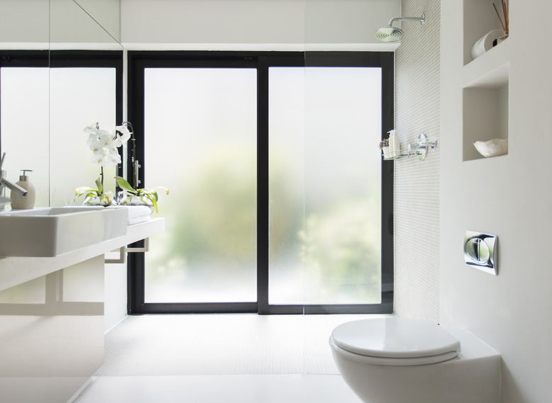 White clean modern bathroom with frosted glass door