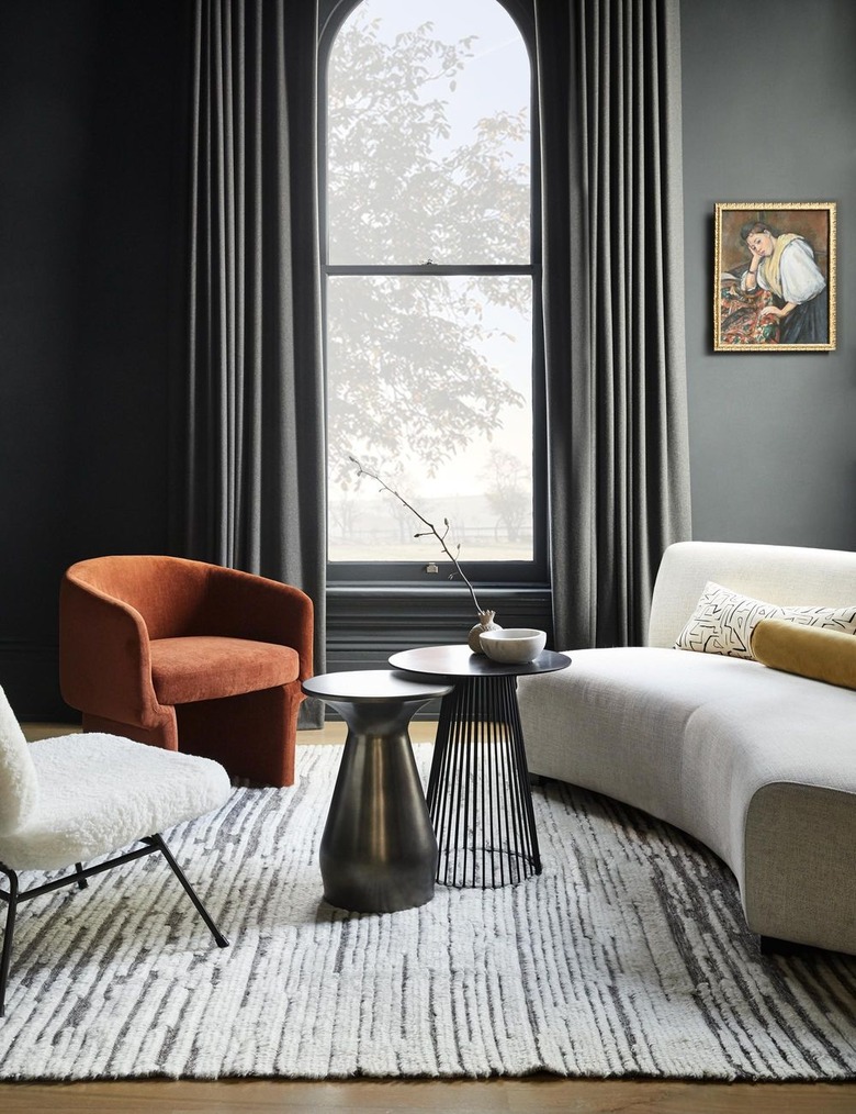 gray room with white sofa and terra cotta color arm chair