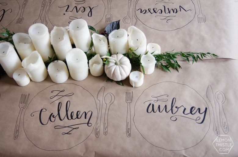 Hand lettered Thanksgiving tablecloth place settings on kraft paper