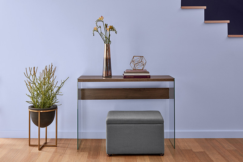 lavender wall with entryway furniture and plant