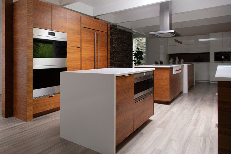 open kitchen with dark wood cabinetry and white countertops