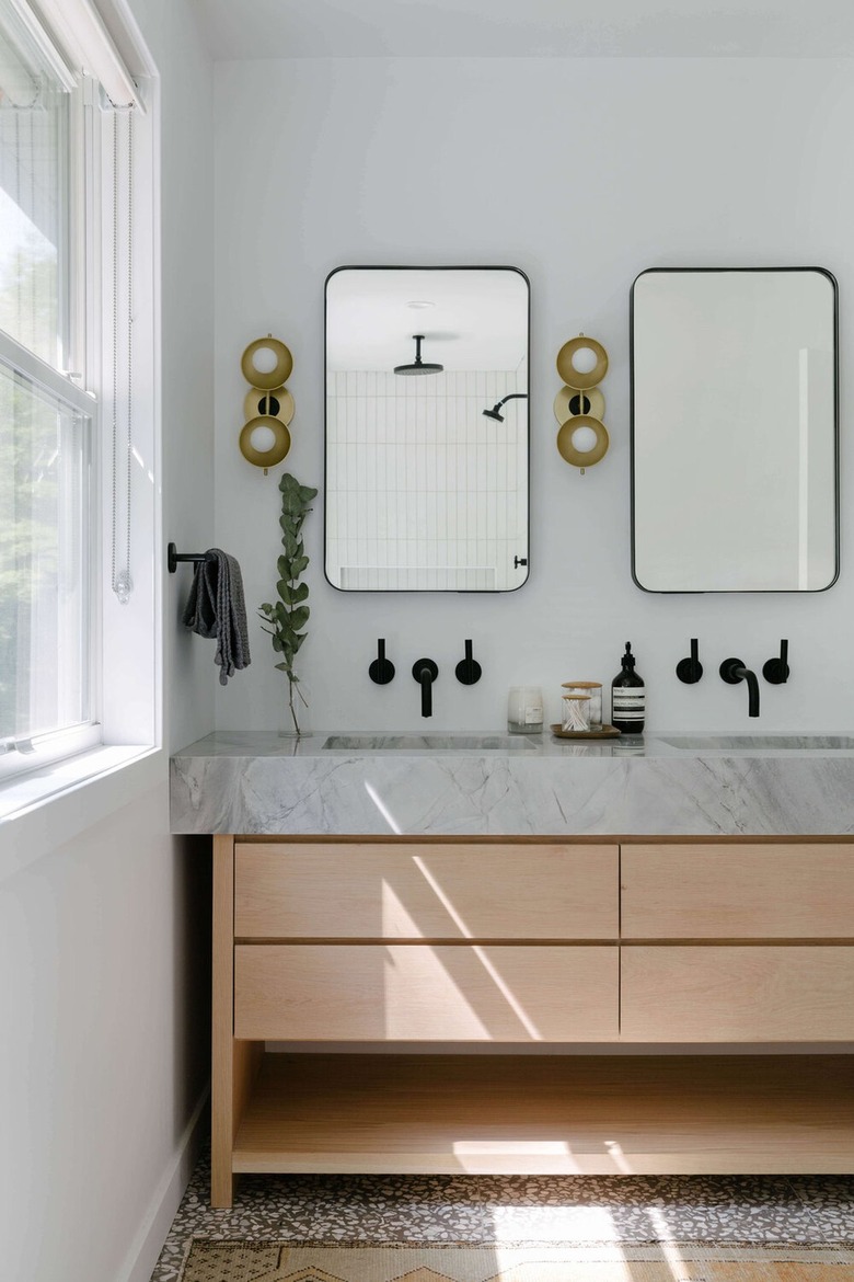 gray bathroom with bronze and brass fixtures