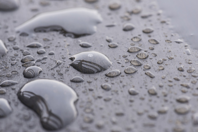 Raindrops on wooden deck close-up