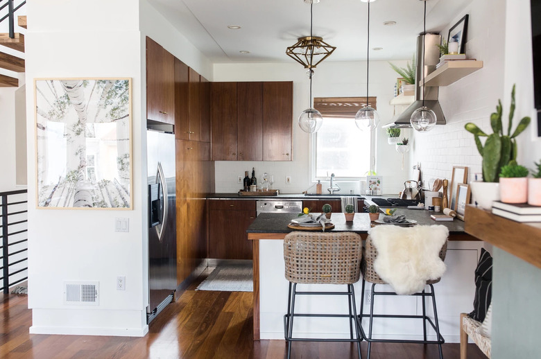 Eclectic bohemian kitchen lighting with wood cabinets and black countertops