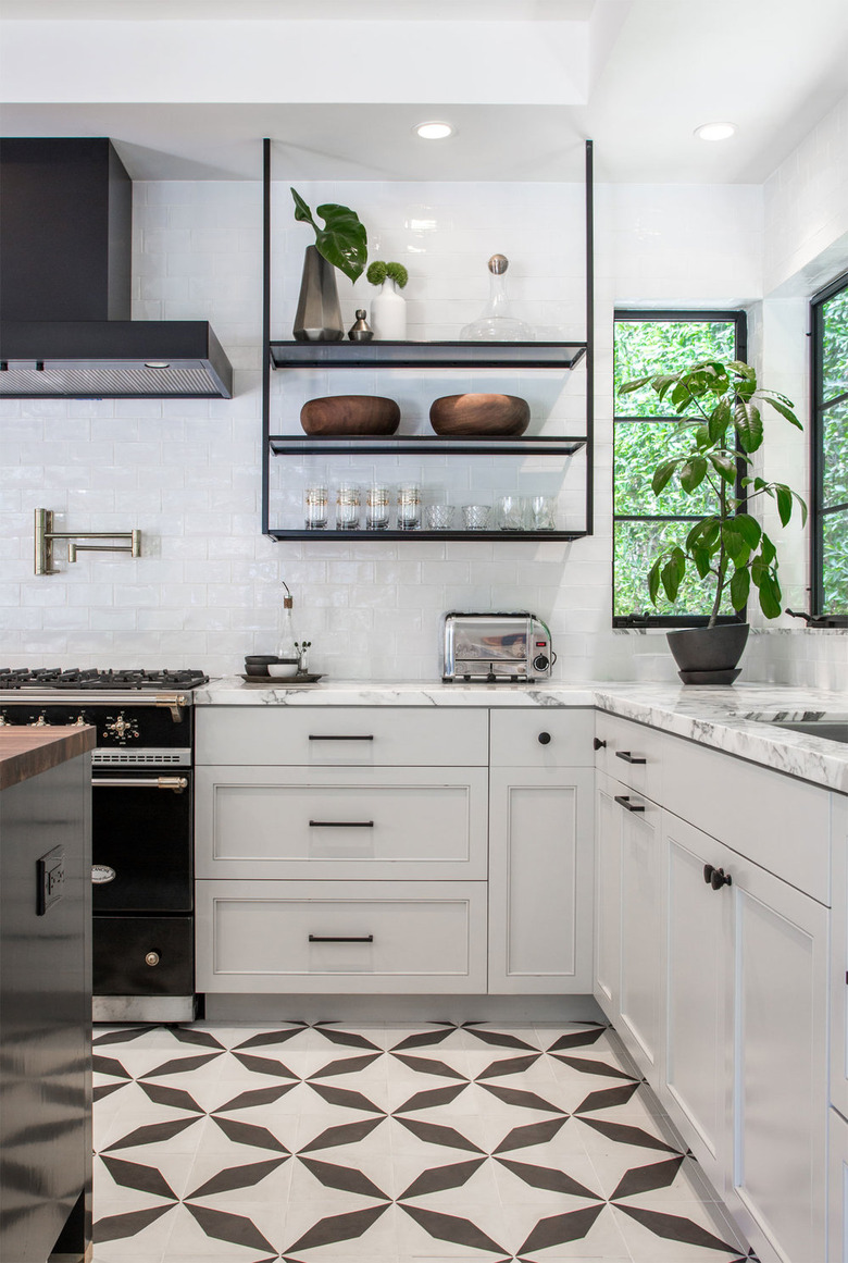 Black and white kitchen floor tile idea with white cabinets and black hardware